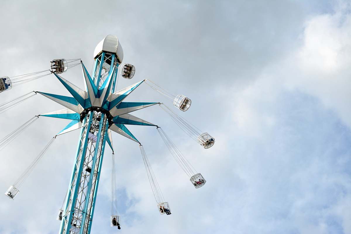 ferris wheel low-angle photography of gray and blue rotating coaster leisure activities
